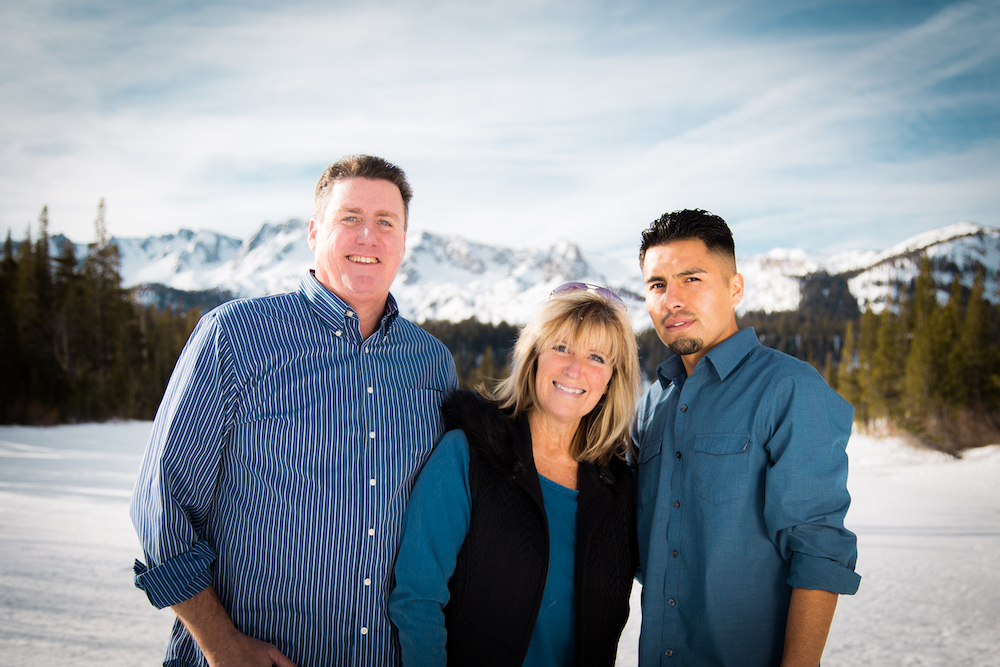 Rich, Kandis and Junior pose for a photo in front of frozen, snowy Twin Lakes in Mammoth Lakes, CA