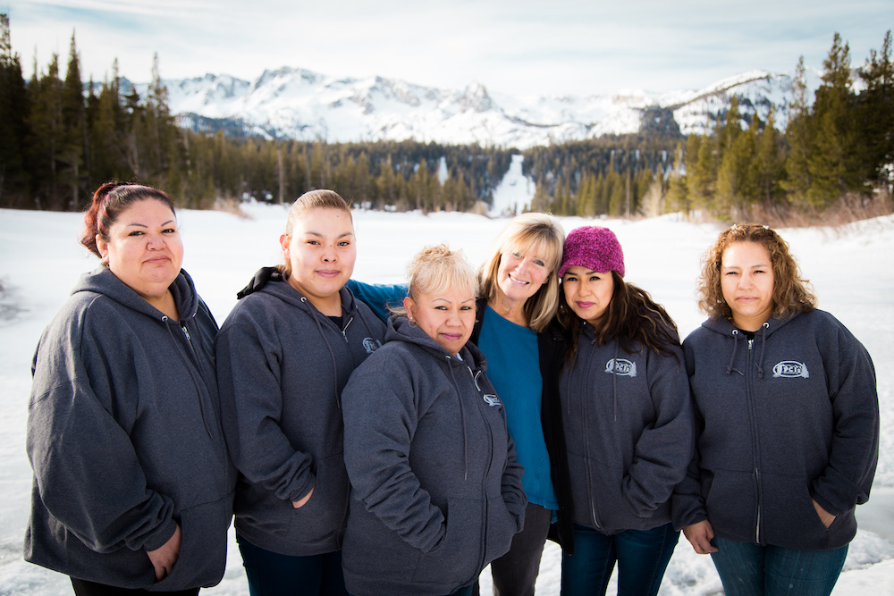 the women of the Perfect Clean Inc. team pose in front of a snowy Twin Lakes in Mammoth Lakes, CA